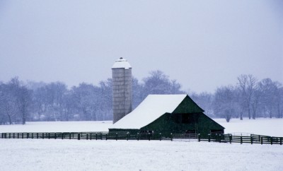 Snow-covered barn and silo
