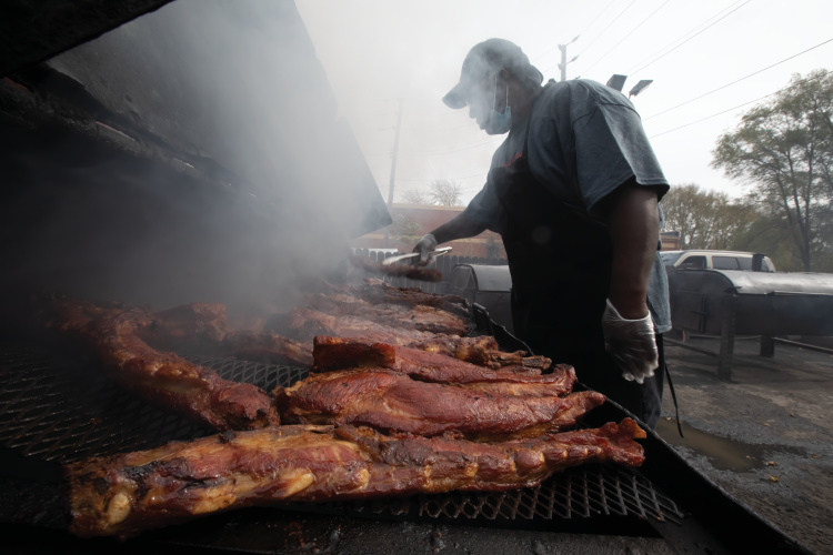 Pitmaster Thomas Fultz checks the smokers at King Ribs. Bottom: Diners enjoy their meals at the 16th Street location.