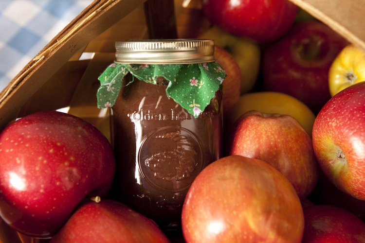 Jar of apple butter and basket of apples