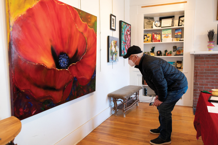 Man viewing an exhibit at Nickel Plate Arts