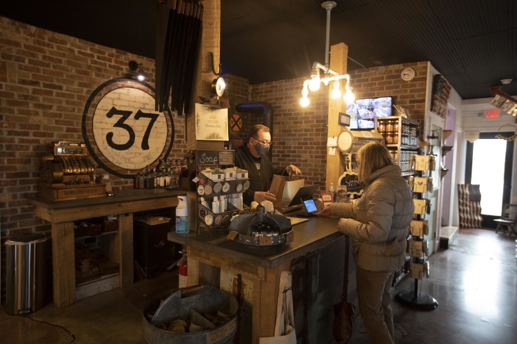 J.R. Roudebush helps out a customer at Mercantile 37