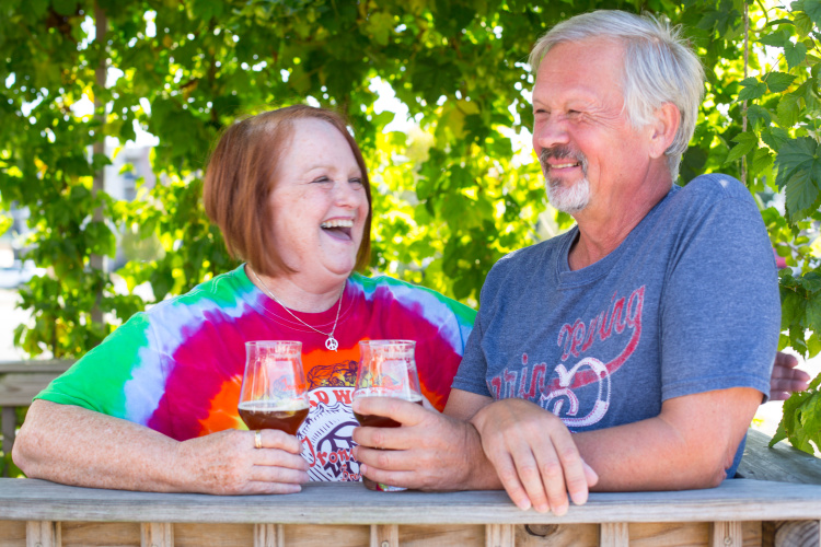 Two people drinking Ironwood brews