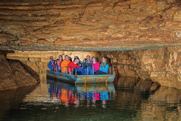 People riding a boat in the Indiana Caverns