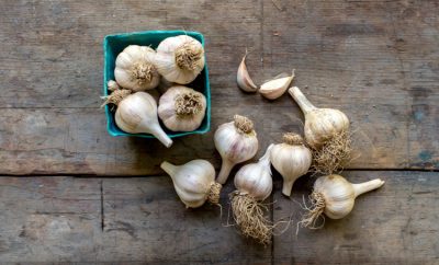 Garlic bulbs and cloves on a wood table