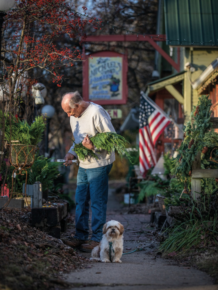 Man shopping with his dog at Michael's Flowers and Gifts