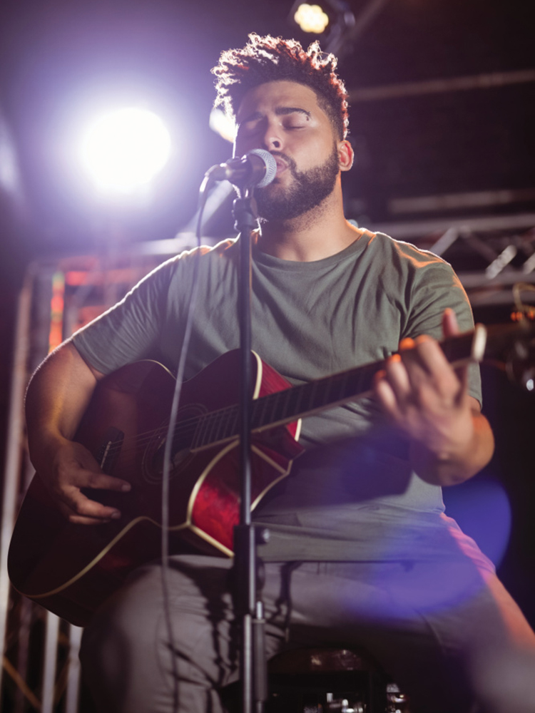 Man playing guitar and singing