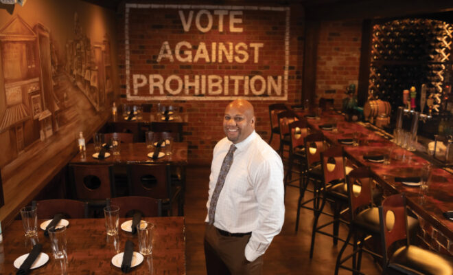 Sherman Bell stands in the dining room of Hideout 125