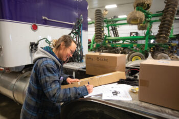 Amy Beebe filling out an order for tractor parts