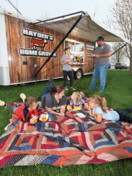 Hayden family having a picnic beside their Hayden's Home Grown food truck
