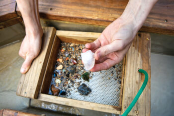 Up-close of someone panning for minerals at Bluespring Caverns 
