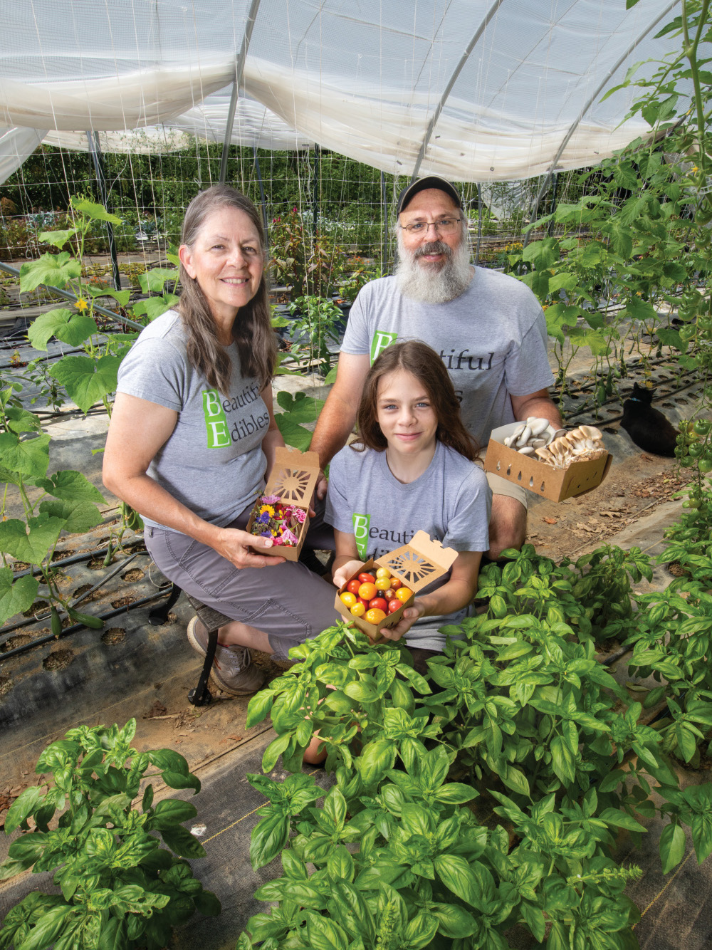 Mary and Roger Winstread with their son Jonathan in a hoop house at Beautiful Edibles