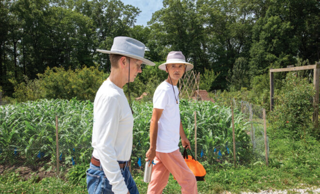 Robert Frew and Juan Carlos Arango walk through the gardens at Sobremesa Farm