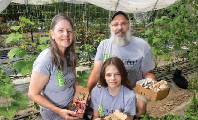 Mary and Roger Winstread with their son Jonathan in a hoop house at Beautiful Edibles
