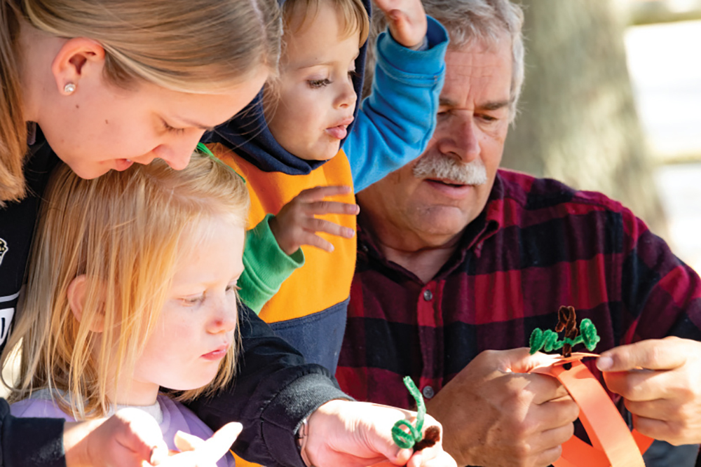 Family making pumpkin crafts at Indiana Halloween events at Monroe Lake