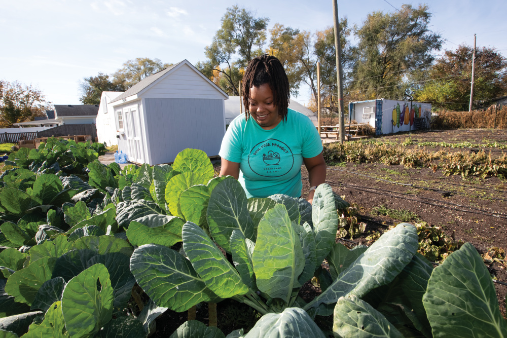 Danielle Guerin harvests collard greens at the soul food project