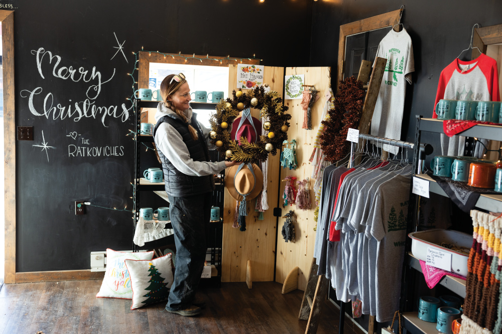 Ashley Ratkovich organizes merchandise in their store