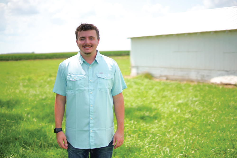 Jayden Simpson in a field at his farm