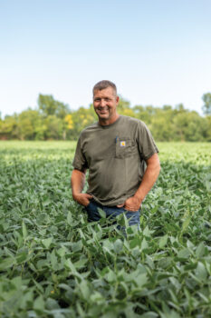 Brent Risner standing in a field at his Starke County farm