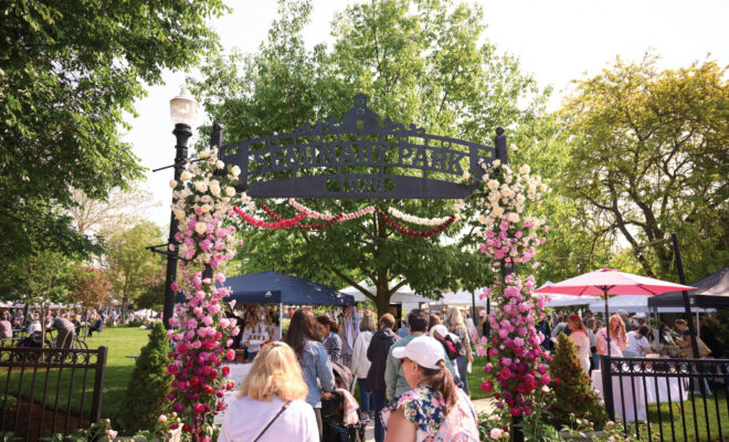 People walking into the entrance of the Indiana Peony Festival, celebrating Indiana's state flower