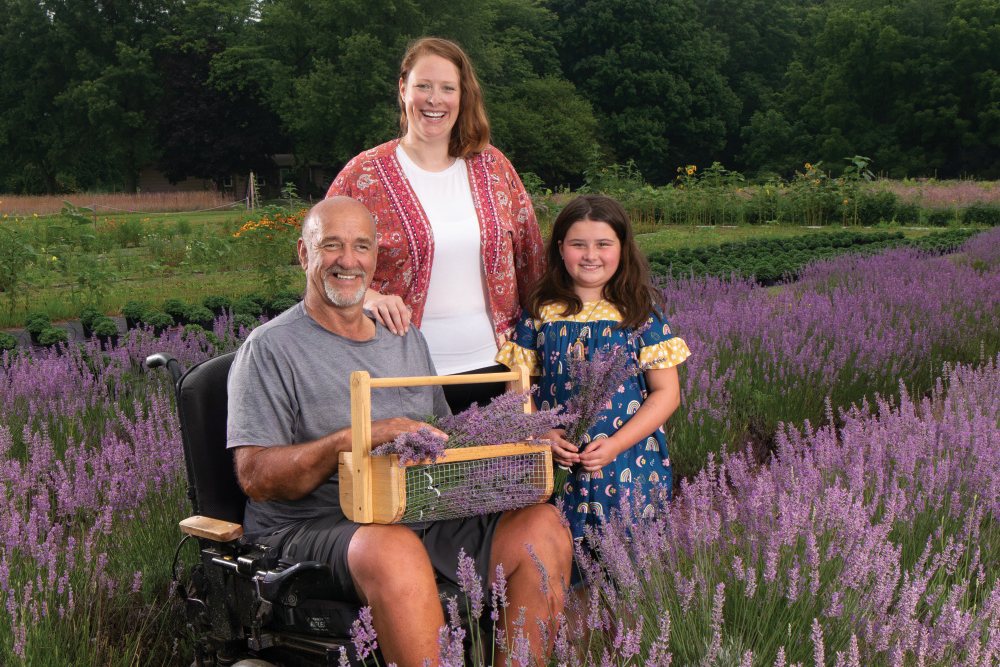 Rich Borkholder with his daughter, Caryn Webster, and granddaughter, Madde Webster, in the lavender fields at Aroma Acres
