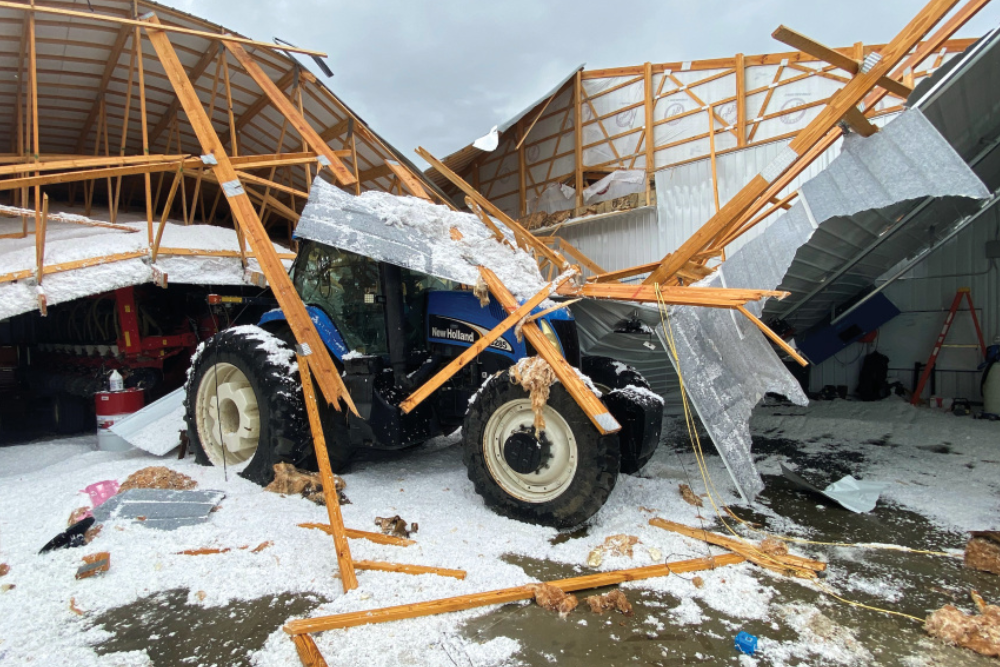 Damaged building and equipment from the tornado at the Kron farm