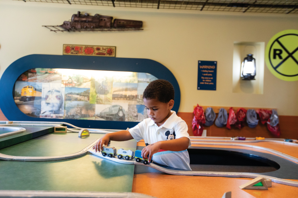 Young boy playing in the train room at Bellaboo’s Play and Discovery Center
