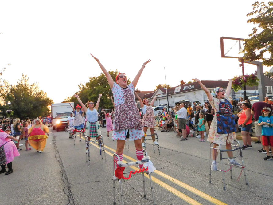 People dressed as elderly women doing a dance routine with walkers 
