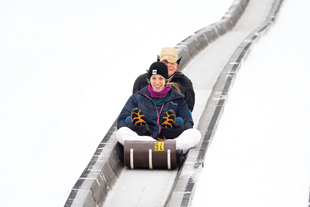 A couple rides down the toboggan run at Pokagon State Park, one of the things to do in Steuben County