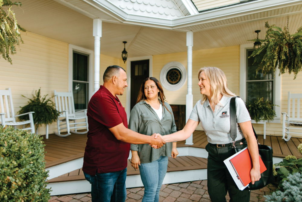 Indiana Farm Bureau agent meets with two members outside their home