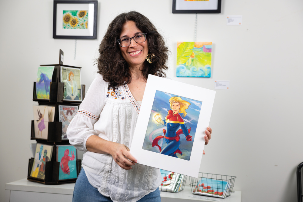 Elisa Barety poses with her Captain Marvel artwork 