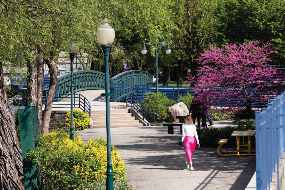 People walk along the Riverwalk, one of the things to do in Elkhart