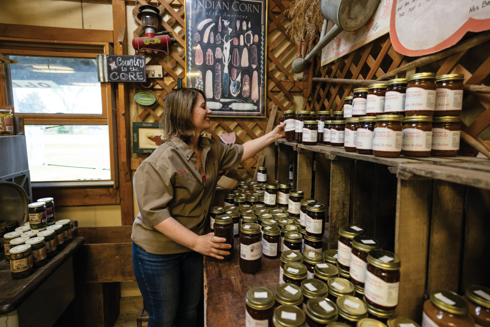 Lisa Chandler stocks jars of apple butter at the market