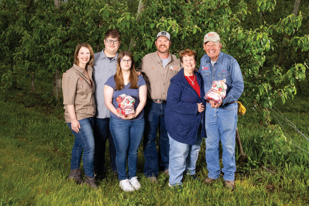 Lisa, Cort, Elle, Matt, Jerry and Vyanne Chandler pose for a photo at their family orchard