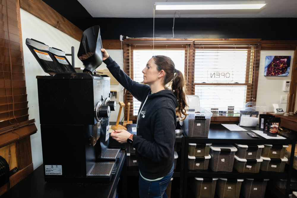 Joana Wade grinds a blend of coffee at JavAroma Roasters