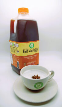 A jug of Bold Masala Chai with a cup of tea in front of it