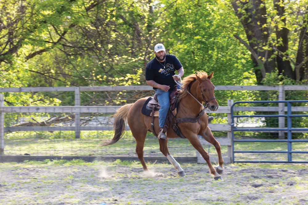 Chris Brown riding a horse at Brown Family Ranch 