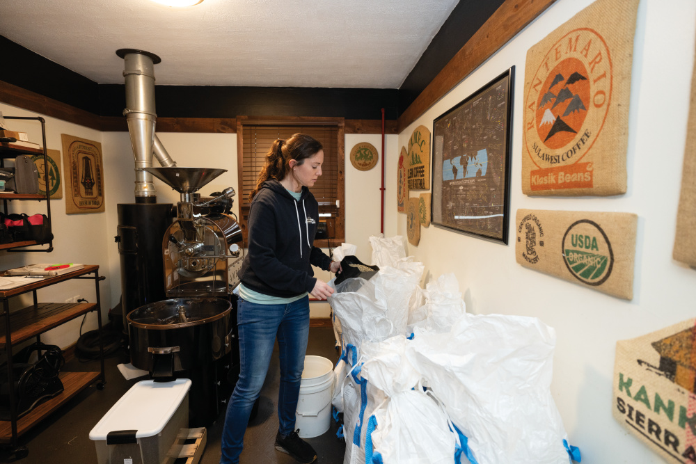 Joana Wade scoops coffee beans to be roasted