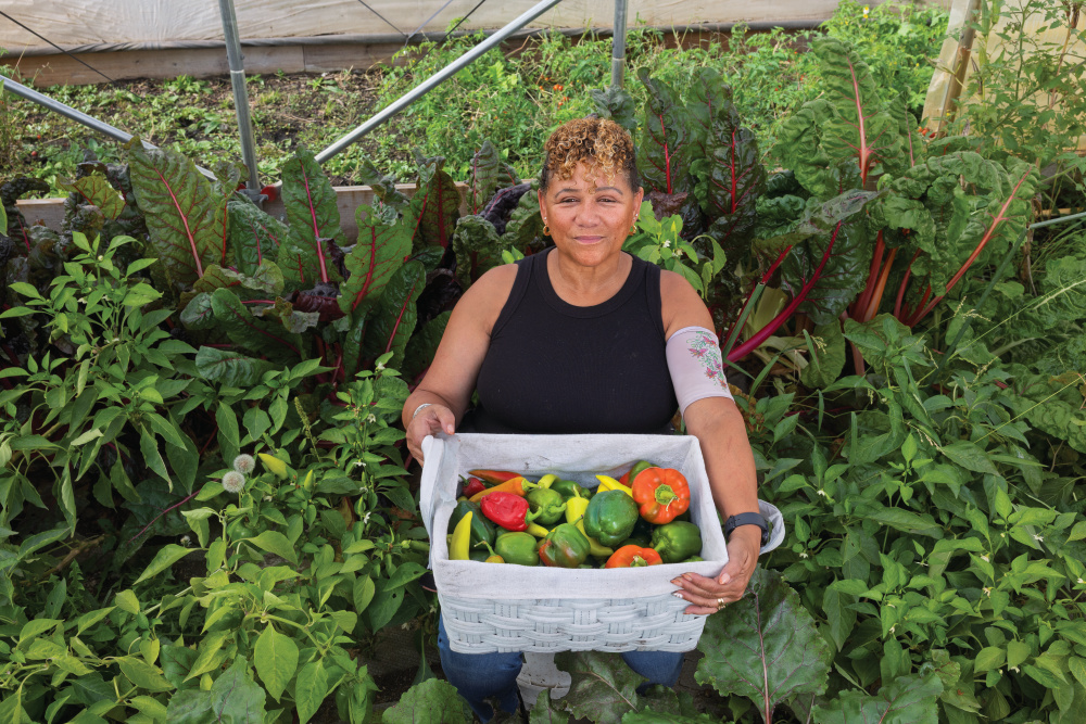 Frieda Graves holds a box of peppers