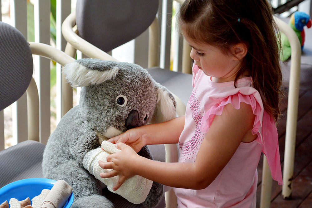 Little girl play pretend to be animal doctor - Veterinary physician